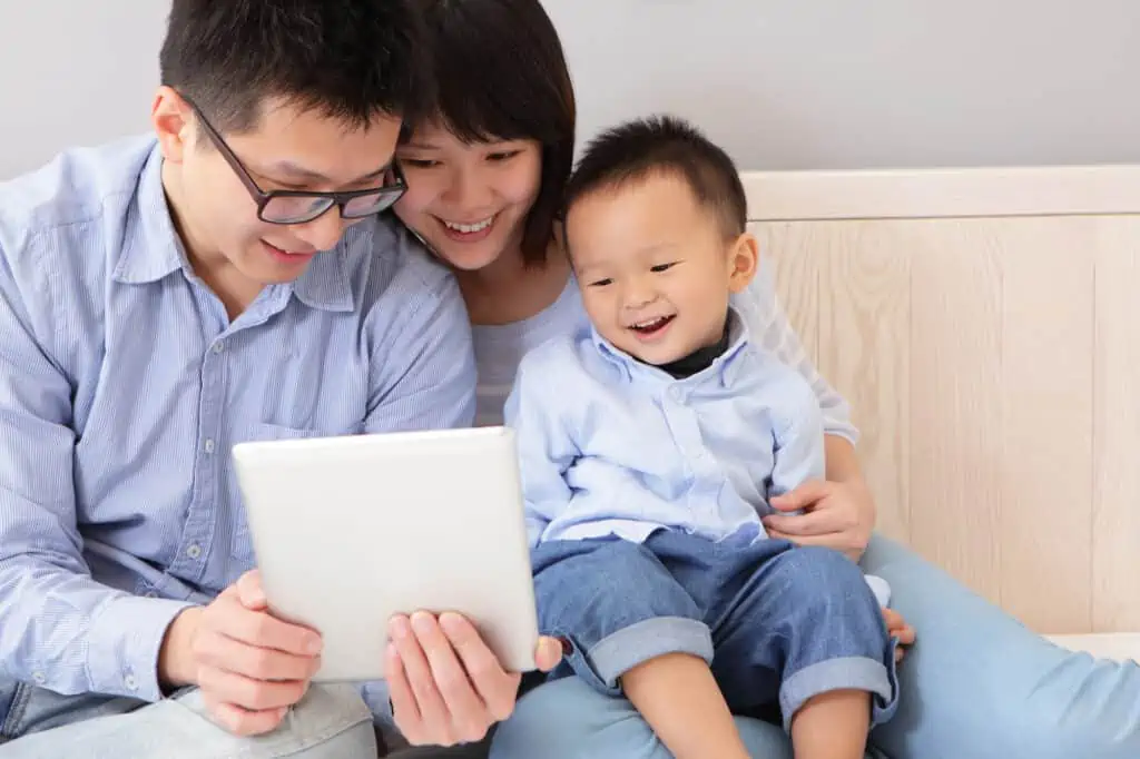 Freedom of Choice for Order of Surname and Given Name, and For Husband and Wife to Have Different Surnames, But What About Countries With Patriarchy Systems? 2 happy family using tablet pc