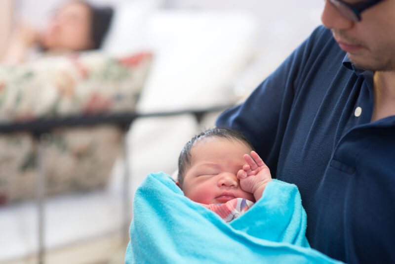 Newborn Asian baby and parents